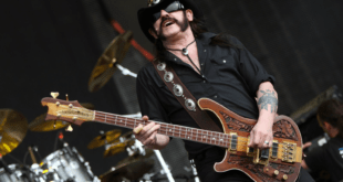 James Hetfield de Metallica, avec son visage expressif et sa guitare électrique, rendant hommage à Lemmy Kilmister de Motörhead, qui arbore son célèbre chapeau de cowboy et joue de la basse avec son énergie caractéristique sur scène.